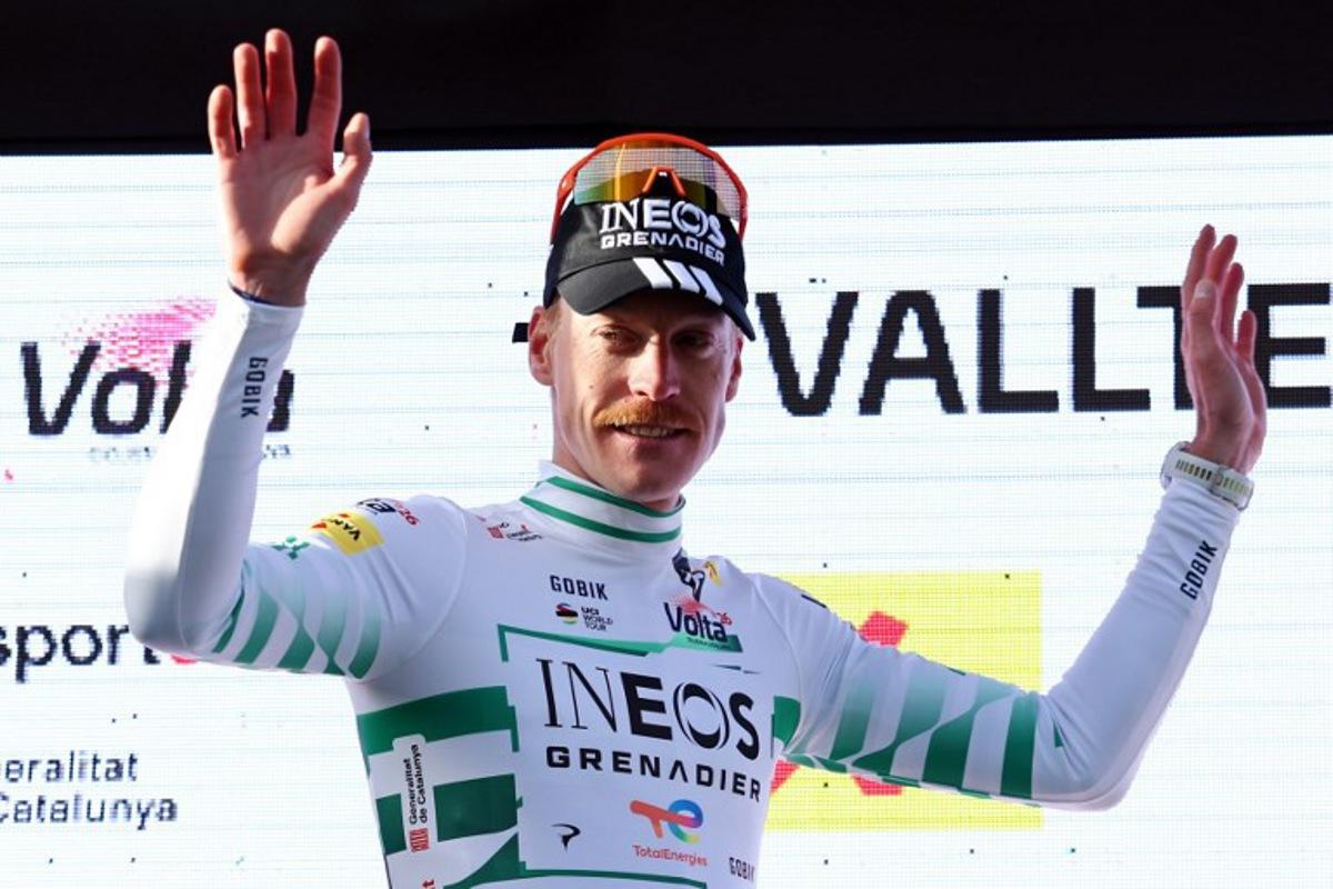 Overall ranking leader Team Ineos' French rider Dorian Godon waves from the podium after the 4th stage of the 2026 Volta a Catalunya cycling tour of Catalonia, a 151 km race between Mataro and  Camprodon, on March 26, 2026.  Josep LAGO / AFP