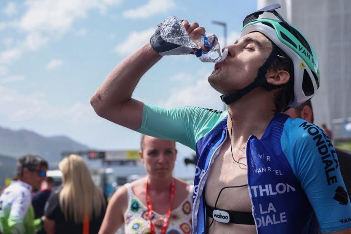 Decathlon AG2R La Mondiale Team's French rider Paul Seixas drinks from a bottle at the end of the 7th stage of the 77th edition of the Criterium du Dauphine cycling race, 131,6 km between Grand-Aigueblanche and Valmeinier, on June 14, 2025.  Anne-Christine POUJOULAT / AFP