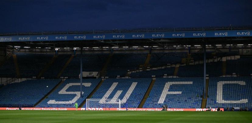 Sheffield Wednesday's US goalkeeper #24 Ethan Horvath takes a kick against empty seats due to a protest against Sheffield Wednesday's Thai owner Dejphon Chansiri during the English League Cup second round football match between Sheffield Wednesday and Leeds United at The Hillsborough Stadium in Sheffield, northern England on August 26, 2025.  Oli SCARFF / AFP