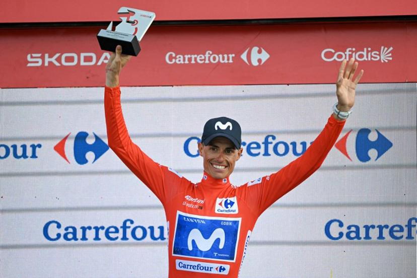 Overall race leader Team Movistar's Spanish rider Enric Mas celebrates retaining the race lead on the podium after the 14th stage of the Vuelta a Espana 2026 cycling tour, a 154,5 km race between Jaen and Sierra de la Pandera, on September 5, 2026.  JORGE GUERRERO / AFP