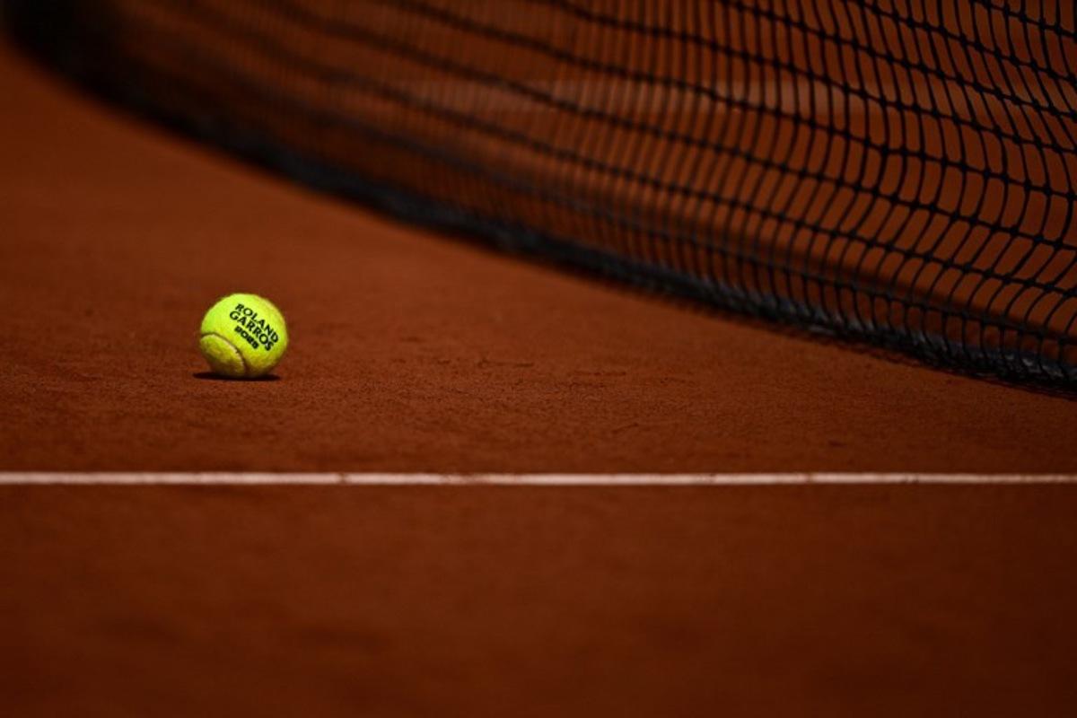 this photograph shows a tennis ball on a clay court during the French Open tennis tournament on day 10 at the Roland-Garros Complex in Paris on June 3, 2025.  JULIEN DE ROSA / AFP