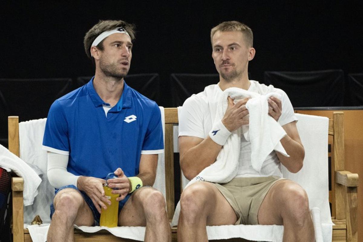 Belgium's Sander Gille (L) and Poland's Jan Zielinski (R) rest in a break during their men's doubles final tennis match against France's Benjamin Bonzi and France's Pierre-Hughes Herbert at the Marseille Open 13 ATP World Tour in Marseille, southern France on February 16, 2025.  MIGUEL MEDINA / AFP