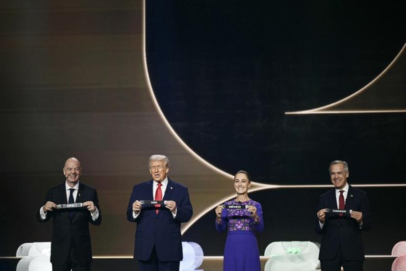 (L-R) FIFA President Gianni Infantino, US President Donald Trump, Mexico's President Claudia Sheinbaum and Canada's Prime Minister Mark Carney hold cards on stage during the draw for the 2026 FIFA Football World Cup taking place in the US, Canada and Mexico, at the Kennedy Center, in Washington, DC, on December 5, 2025.  Brendan SMIALOWSKI / AFP