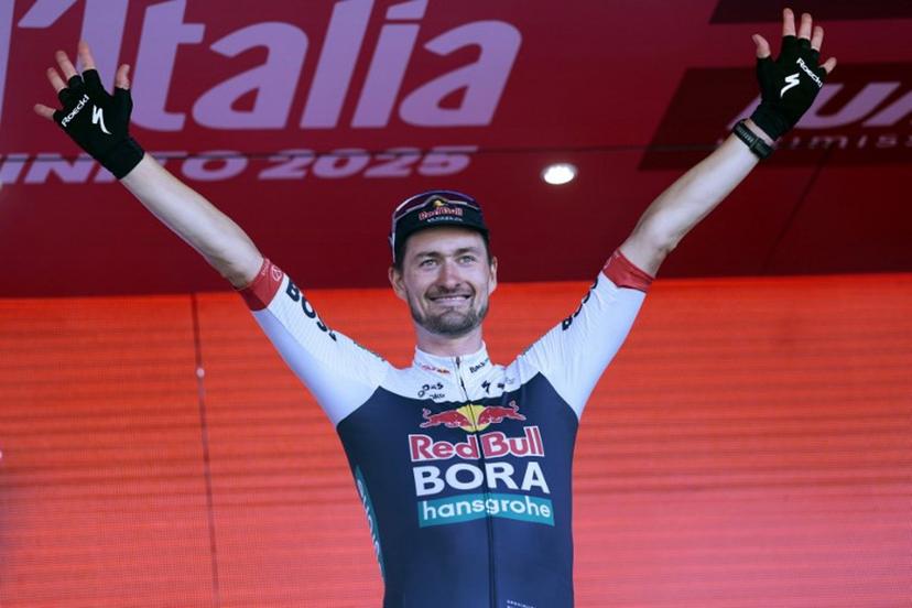 Red Bull-Bora-Hansgrohe's Germany rider Nico Denz celebrates on the podium after wnning the 18th stage of the 108th Giro d'Italia cycling race of 144kms from Morbegno to Cesano Maderno on May 29, 2025.  Luca Bettini / AFP