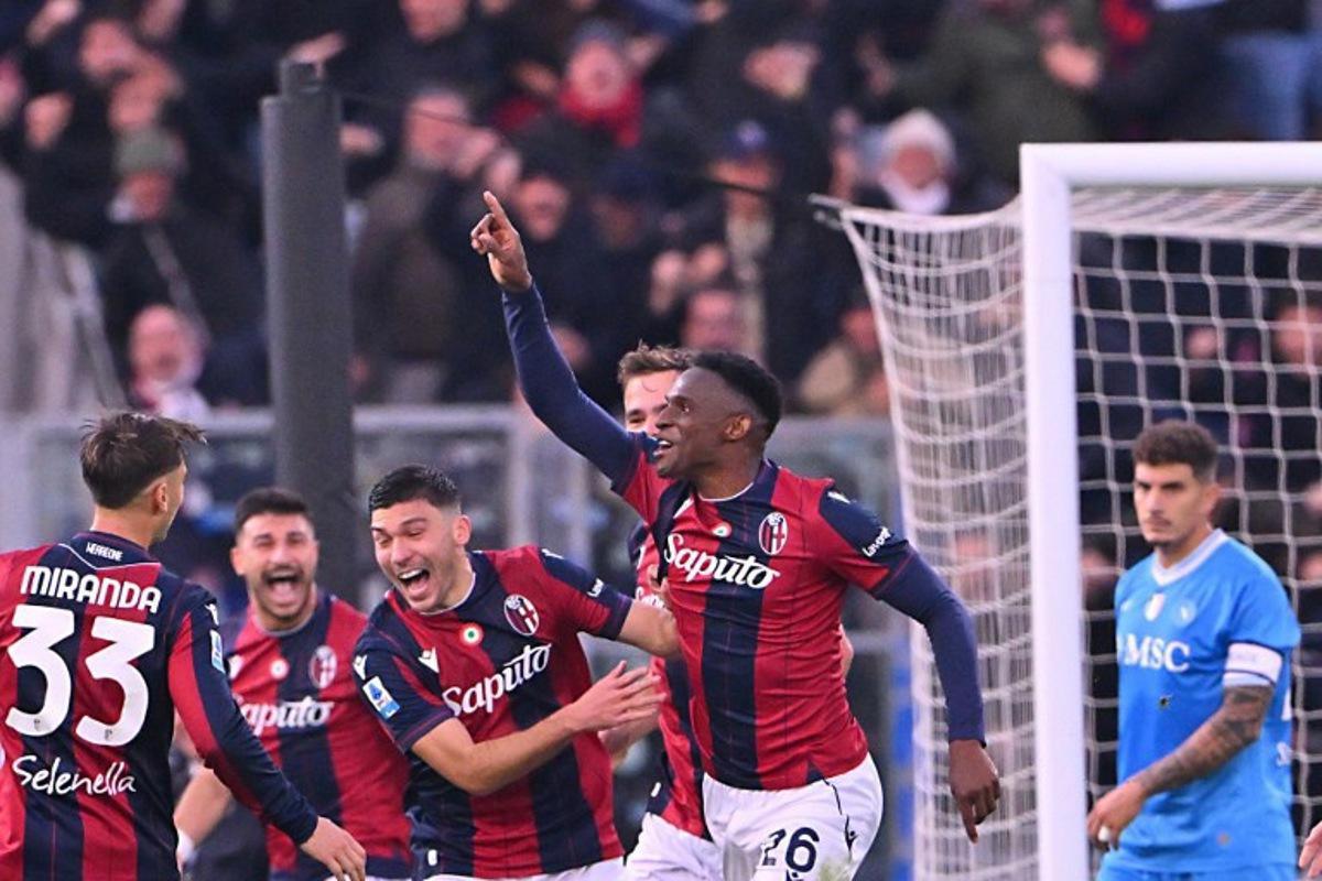 Bologna's Colombian defender #26 Jhon Lucumi (C) celebrates with teammates after scoring during the Italian Serie A football match between Bologna and Napoli at the Renato Dall'Ara stadium in Bologna on April 7, 2025.  Andreas SOLARO / AFP
