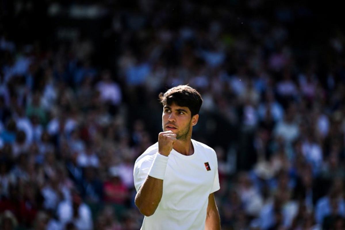 Spain's Carlos Alcaraz celebrates after winning a point against Britain's Oliver Tarvet during their men's singles second round tennis match on the third day of the 2025 Wimbledon Championships at The All England Lawn Tennis and Croquet Club in Wimbledon, southwest London, on July 2, 2025.  Kirill KUDRYAVTSEV / AFP