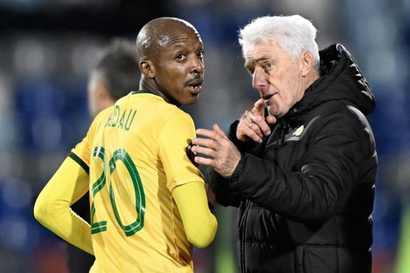 South Africa's head coach Hugo Broos (R) gives instructions to South Africa's defender #20 Khuliso Mudau (L) during the Africa Cup of Nations (CAN) Group B football match between South Africa and Angola at Marrakesh Stadium in Marrakesh, Morocco on December 22, 2025.   Khaled DESOUKI / AFP