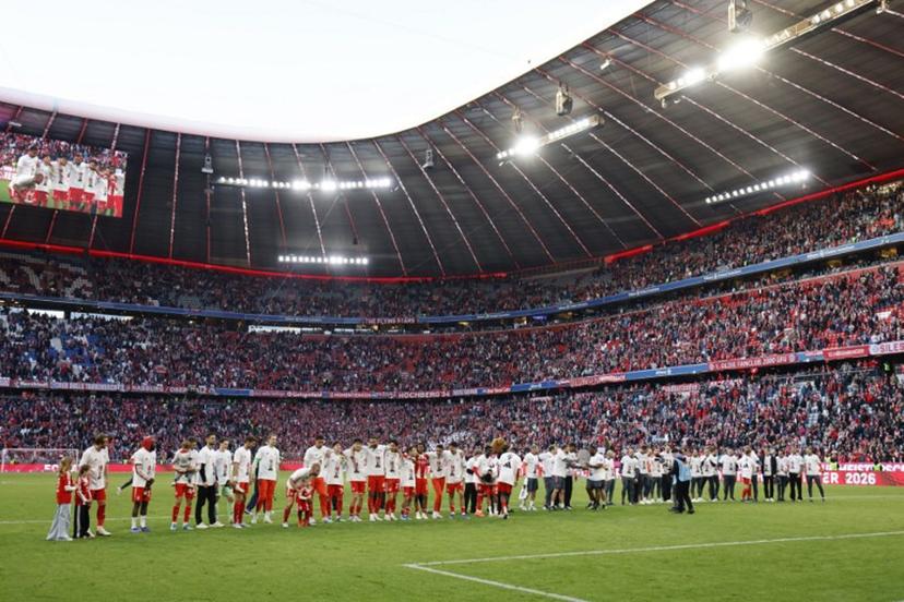 FC Bayern Munich's team celebrates with fans after winning the German first division Bundesliga football match between FC Bayern Munich and VfB Stuttgart in Munich, southern Germany, on April 19, 2026. Harry Kane scored his 32nd goal of the campaign as Bayern Munich cruised to a 4-2 home win over Stuttgart and claim a record-extending 35th Bundesliga title.  Alexandra BEIER / AFP
