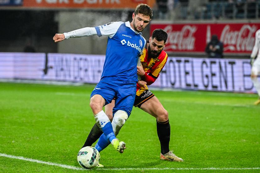 Gent's Hugo Cuypers and Mechelen's Elias Cobbaut fight for the ball during a soccer match between KAA Gent and KV Mechelen, Friday 19 January 2024 in Gent, on day 21 of the 2023-2024 season of the 'Jupiler Pro League' first division of the Belgian championship. BELGA PHOTO LAURIE DIEFFEMBACQ