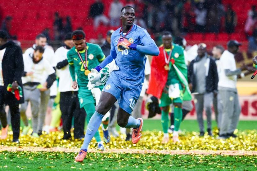 Senegal's goalkeeper #16 Edouard Mendy and his teammates celebrate their victory at the end of the Africa Cup of Nations (CAN) final football match against Morocco at the Prince Moulay Abdellah Stadium in Rabat on January 18, 2026.  FRANCK FIFE / AFP