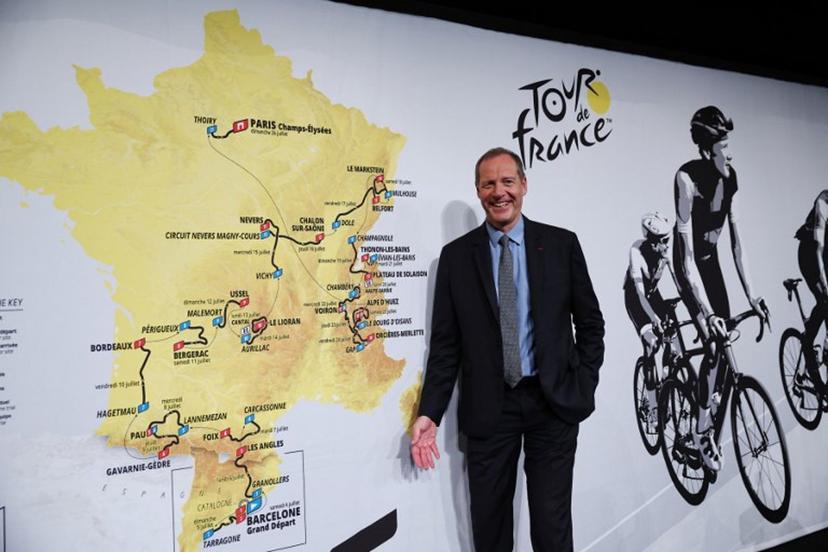 Tour de France General Director Christian Prudhomme poses for a picture in front of the map showing the women's route during the presentation of the official routes of the 2026 edition of the men's and women's Tour de France cycling race in Paris on October 23, 2025.   Anne-Christine POUJOULAT / AFP