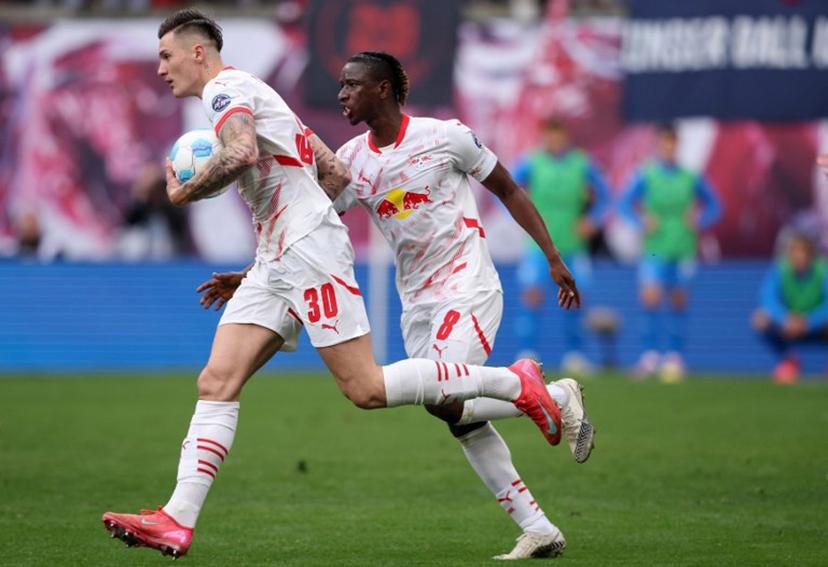 Leipzig's Slovenian forward #30 Benjamin Sesko (L) celebrates scoring the 1-1 goal with his teammate Leipzig's Malian midfielder #08 Amadou Haidara during the German first division Bundesliga football match between RB Leipzig and Holstein Kiel in Leipzig, eastern Germany on April 19, 2025.  RONNY HARTMANN / AFP