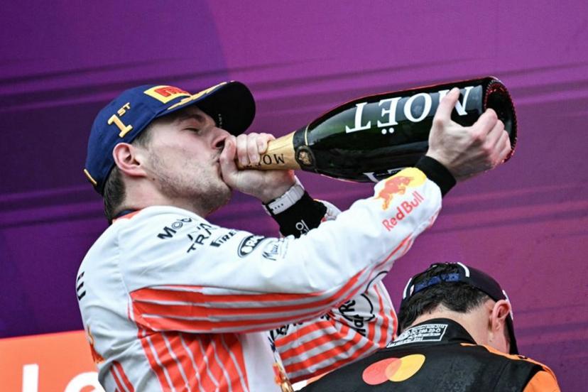 Red Bull Racing's Dutch driver Max Verstappen drinks champagne on the podium after winning the Formula One Japanese Grand Prix at the Suzuka circuit in Suzuka, Mie prefecture, Japan on April 6, 2025.  Philip FONG / AFP