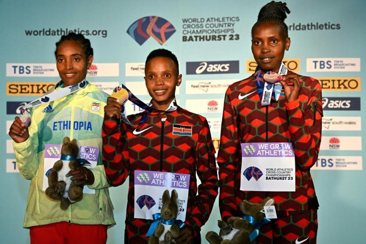 Women's senior race winners, gold medallist Beatrice Chebet of Kenya (C), silver medallist Tsigie Gebreselama of Ethiopia (L) and bronze medalist Agnes Jebet Ngetich of Kenya (R) pose with their medals after the 2023 World Cross Country Championships at Mount Panorama in Bathusrt on February 18, 2023.  Saeed KHAN / AFP