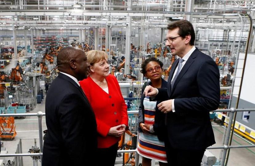 South Africa's President Cyril Ramaphosa (L), BMW Head of Productions Milan Nedeljkovic (R), German Chancellor Angela Merkel (2ndL) and South Africa's Minister of Small Business Development Khumbudzo Ntshavheni (2ndR), speak during a visit to the BMW Group production plant in Rosslyn, Pretoria on February 6, 2020.  Phill Magakoe / AFP