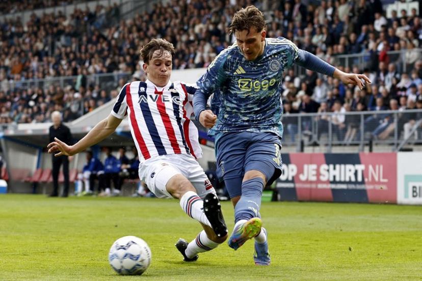 Willem II Dutch defender #48 Jens Mathijsen (L) fights for the ball with Ajax's Belgian forward #11 Mika Godts during the Dutch Eredivisie football match between Willem II and AFC Ajax at the Koning Willem II Stadium in Tilburg on April 13, 2025.  MAURICE VAN STEEN / ANP / AFP