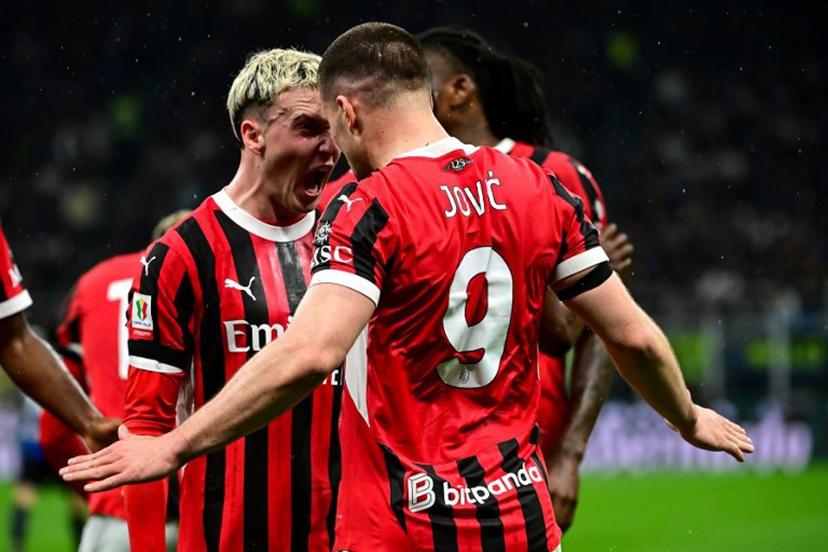 AC Milan's Serbian forward #09 Luka Jovic (R) celebrates with AC Milan's Spanish defender #20 Alejandro Jimenez Sanchez (L) after scoring AC Milan's first goal during the Coppa Italia second leg semi-final football match between Inter Milan and AC Milan at the San Siro stadium in Milan on April 23, 2025.  Piero CRUCIATTI / AFP