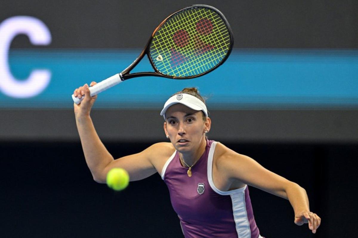 Belgium's Elise Mertens hits a return to Poland's Iga Swiatek during their women's singles quarter-final at the China Open tennis tournament in Beijing on October 9, 2026.  GREG BAKER / AFP