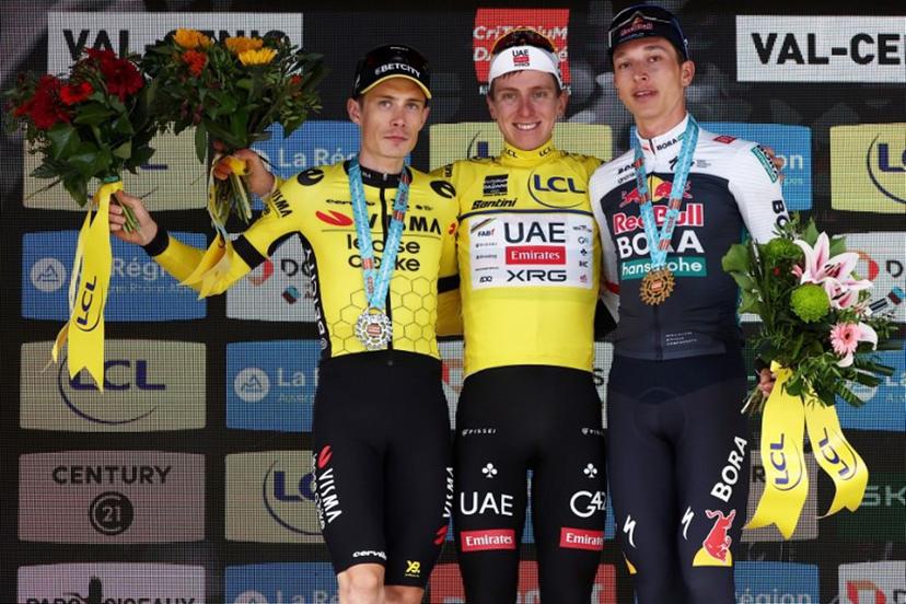 Second placed for the overall race Team Visma - Lease a Bike's Danish rider Jonas Vingegaard, first placed UAE Team Emirates XRG's Slovenian rider Tadej Pogačar wearing the overall leader's yellow jersey and third placed Red Bull - BORA - hansgrohe's German rider Florian Lipowitz celebrate on the podium of the 8th and final stage of the 77th edition of the Criterium du Dauphine cycling race, 133,3 km between Val-d'Arc and Val-Cenis - Plateau du Mont Cenis, on June 15, 2025.  Anne-Christine POUJOULAT / AFP