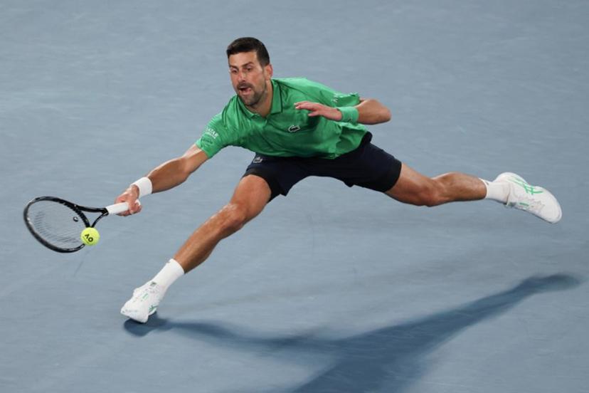 Serbia's Novak Djokovic hits a return against Spain's Pedro Martinez during their men's singles match on day two of the Australian Open tennis tournament in Melbourne on January 19, 2026.  IZHAR KHAN / AFP