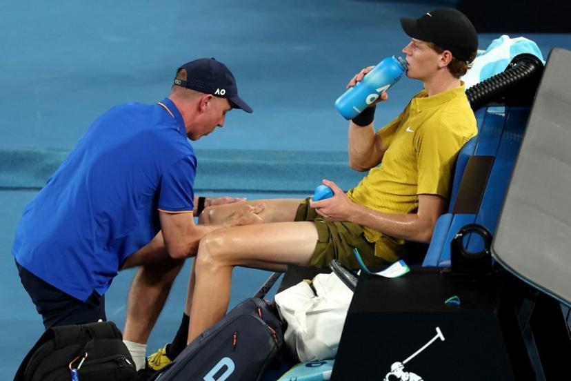 Italy's Jannik Sinner gets medical attention between the games against USA's Eliot Spizzirri during their men's singles match on day seven of the Australian Open tennis tournament in Melbourne on January 24, 2026.  Martin KEEP / AFP