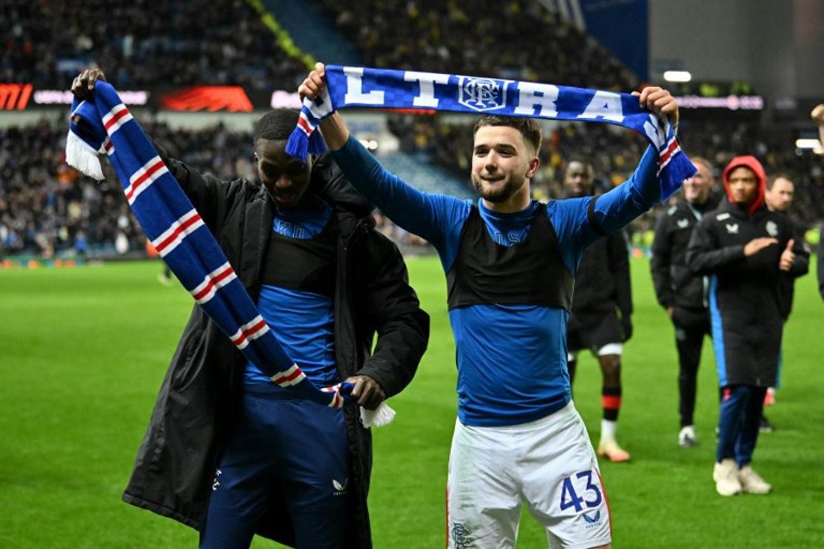 Rangers' Belgian midfielder #43 Nicolas Raskin and Rangers' Ivorian midfielder #10 Mohammed Diomande (L) celebrate following the UEFA Europa League second-leg round of 16 football match between Rangers and Fenerbahce SK at the Ibrox Stadium in Glasgow on March 13, 2025.  ANDY BUCHANAN / AFP