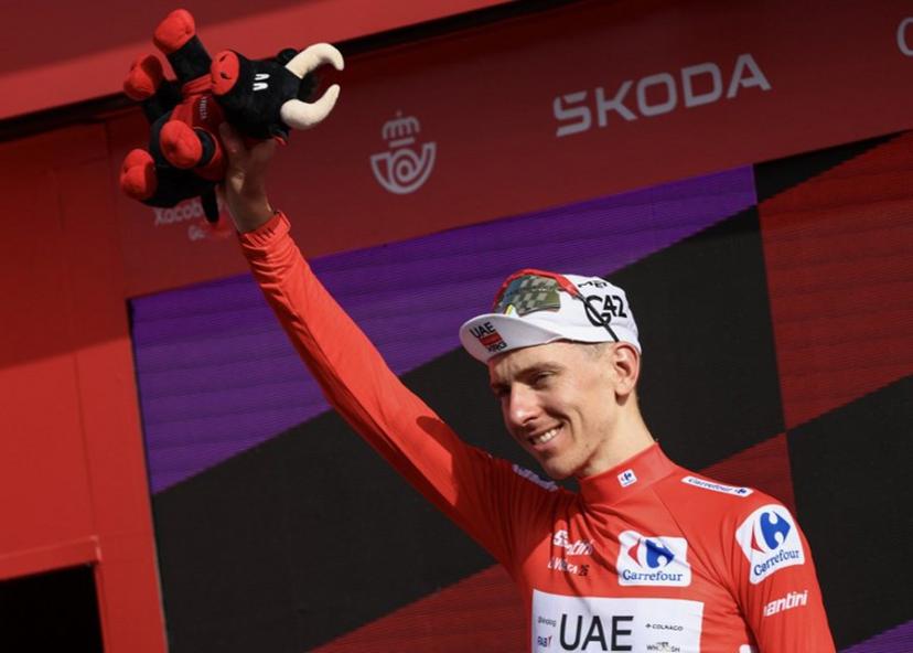 Overall race leader UAE Team Emirates - XRG team's Slovenian rider Tadej Pogacar celebrates on the podium the fifth stage of the Vuelta a Espana 2026, a 173,4 km race between Falset and Roquetes on August 26, 2026.    Josep LAGO / AFP
