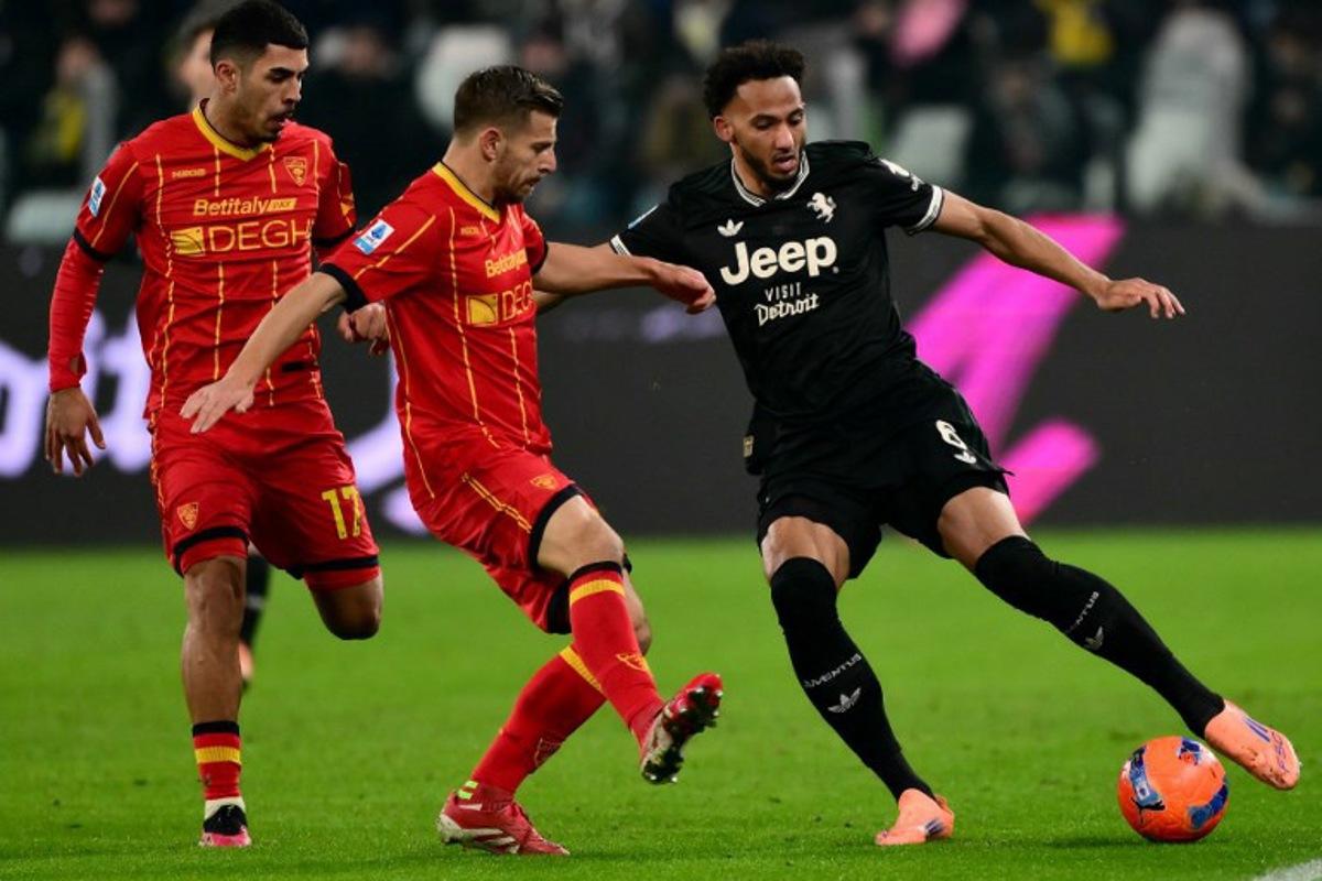 Lecce's Albanian midfielder #20 Ylber Ramadani (C) and Juventus' English defender #06 Lloyd Kelly (R) fight for the ball during the Italian Serie A football match between Juventus and Lecce at the Allianz Stadium in Turin on January 3, 2026.  MARCO BERTORELLO / AFP