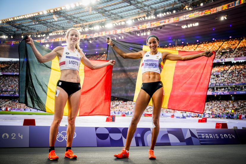 Bronze medal winner Belgian athlete Noor Vidts and Gold medal winner Belgian athlete Nafissatou Nafi Thiam celebrate with the Belgian flag after the 800m, seventh and final event of the women's heptathlon at the athletics competition at the Paris 2024 Olympic Games, on Friday 09 August 2024 in Paris, France. The Games of the XXXIII Olympiad are taking place in Paris from 26 July to 11 August. The Belgian delegation counts 165 athletes competing in 21 sports. BELGA PHOTO JASPER JACOBS