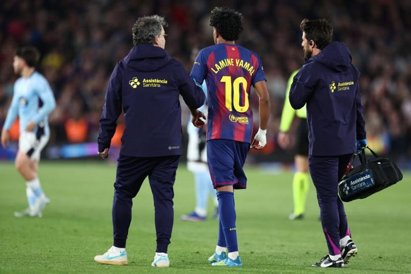 Barcelona's Spanish forward #10 Lamine Yamal leaves the pitch after sustaining an injury during the Spanish league football match between FC Barcelona and RC Celta de Vigo at Camp Nou stadium in Barcelona on April 22 , 2026.  Josep LAGO / AFP