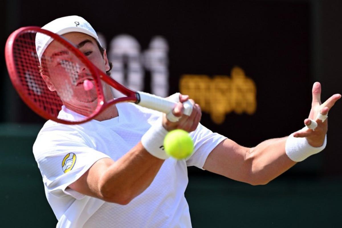 Brazil's Joao Fonseca returns to Russia's Roman Safiullin during their men's singles third round tennis match on the fifth day of the 2026 Wimbledon Championships at The All England Lawn Tennis and Croquet Club in Wimbledon, southwest London, on July 3, 2026.  Kirill KUDRYAVTSEV / AFP