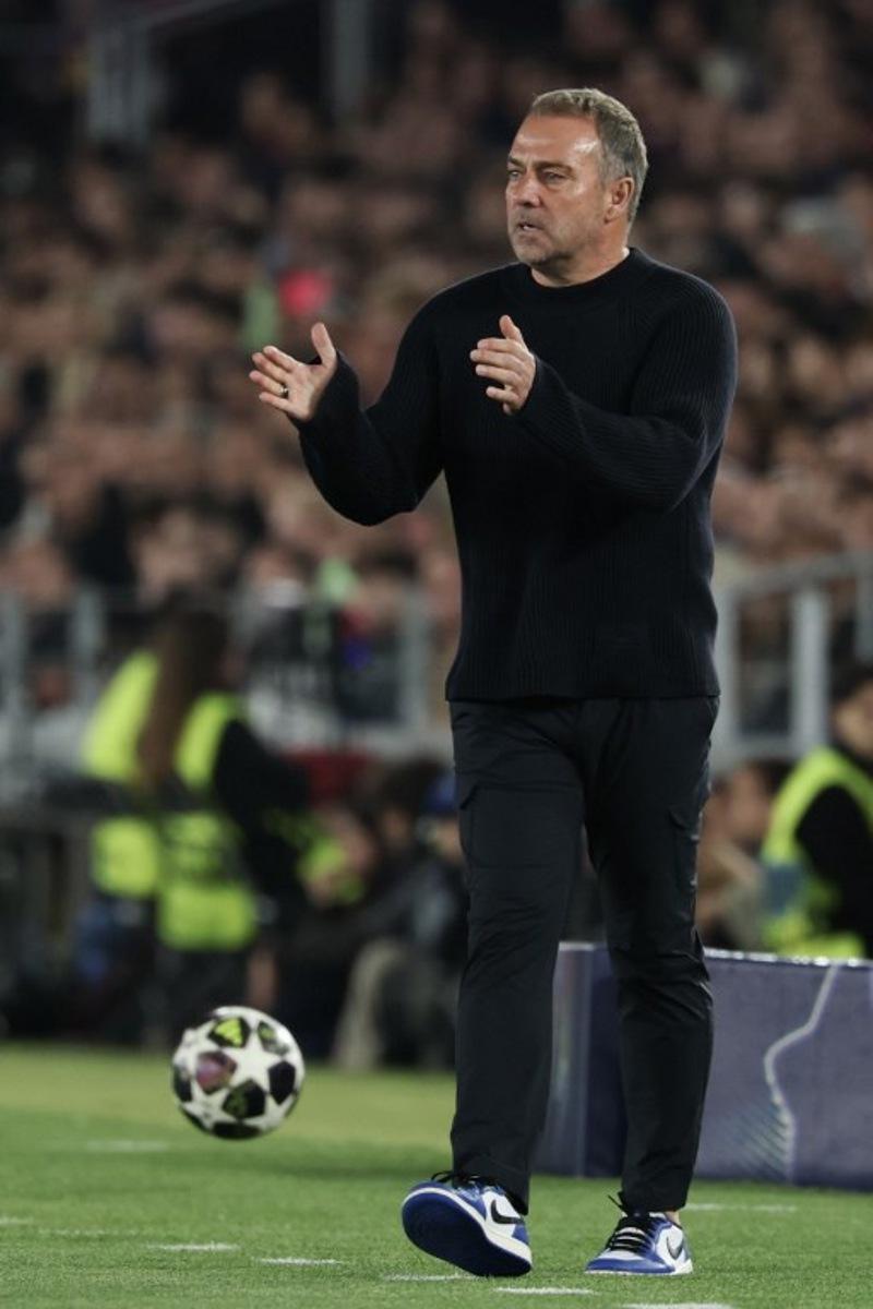Barcelona's German coach Hans-Dieter Flick gestures to players during the UEFA Champions League quarter final first leg football match between FC Barcelona and Club Atletico de Madrid at Camp Nou Stadium in Barcelona on April 8, 2026.  Lluis GENE / AFP