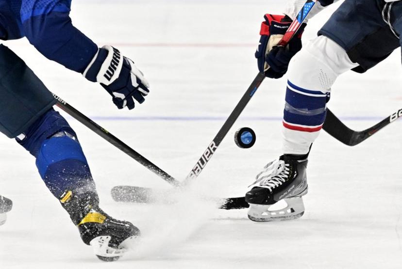 USA's Jessica Compher (R) vies for the puck with Finland's Minnamari Tuominen during their women's preliminary round group A match of the Beijing 2022 Winter Olympic Games ice hockey competition, at the Wukesong Sports Centre in Beijing on February 3, 2022.  Anthony WALLACE / AFP