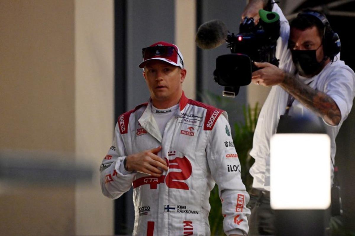 Alfa Romeo's Finnish driver Kimi Raikkonen walks back in his team's hospitality after he retired from the race at the Yas Marina Circuit during the Abu Dhabi Formula One Grand Prix on December 12, 2021.  ANDREJ ISAKOVIC / AFP