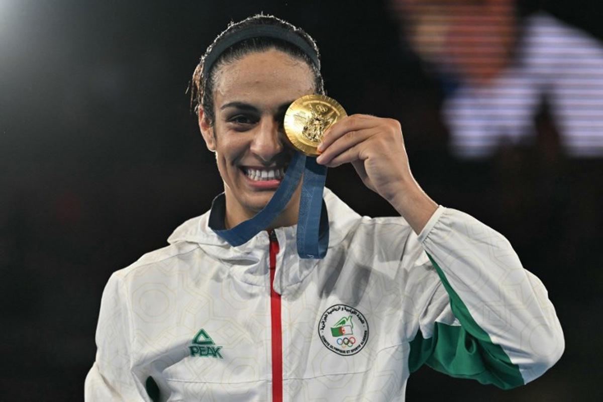 Gold medallist Algeria's Imane Khelif poses on the podium during the medal ceremony for the women's 66kg final boxing category during the Paris 2024 Olympic Games at the Roland-Garros Stadium, in Paris on August 9, 2024.  MOHD RASFAN / AFP