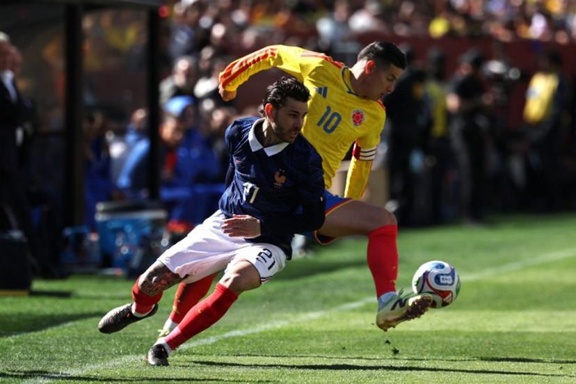 Colombia's midfielder #10 James Rodriguez and France's defender #21 Lucas Hernandez fight for the ball during a friendly football match between Colombia and France at Northwest Stadium in Landover, Maryland, on March 29, 2026.  FRANCK FIFE / AFP