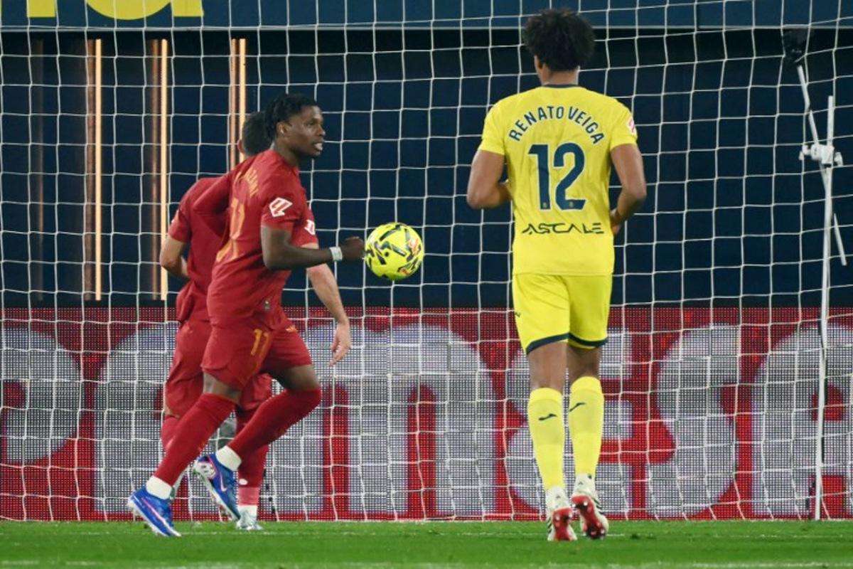 Valencia's Belgian forward # 17 Largie Ramazani celebrates after scoring the opening goal from the penalty spot during the Spanish league football match between Villarreal CF and Valencia CF at La Ceramica Stadium in Vila-real on February 22, 2026.  JOSE JORDAN / AFP