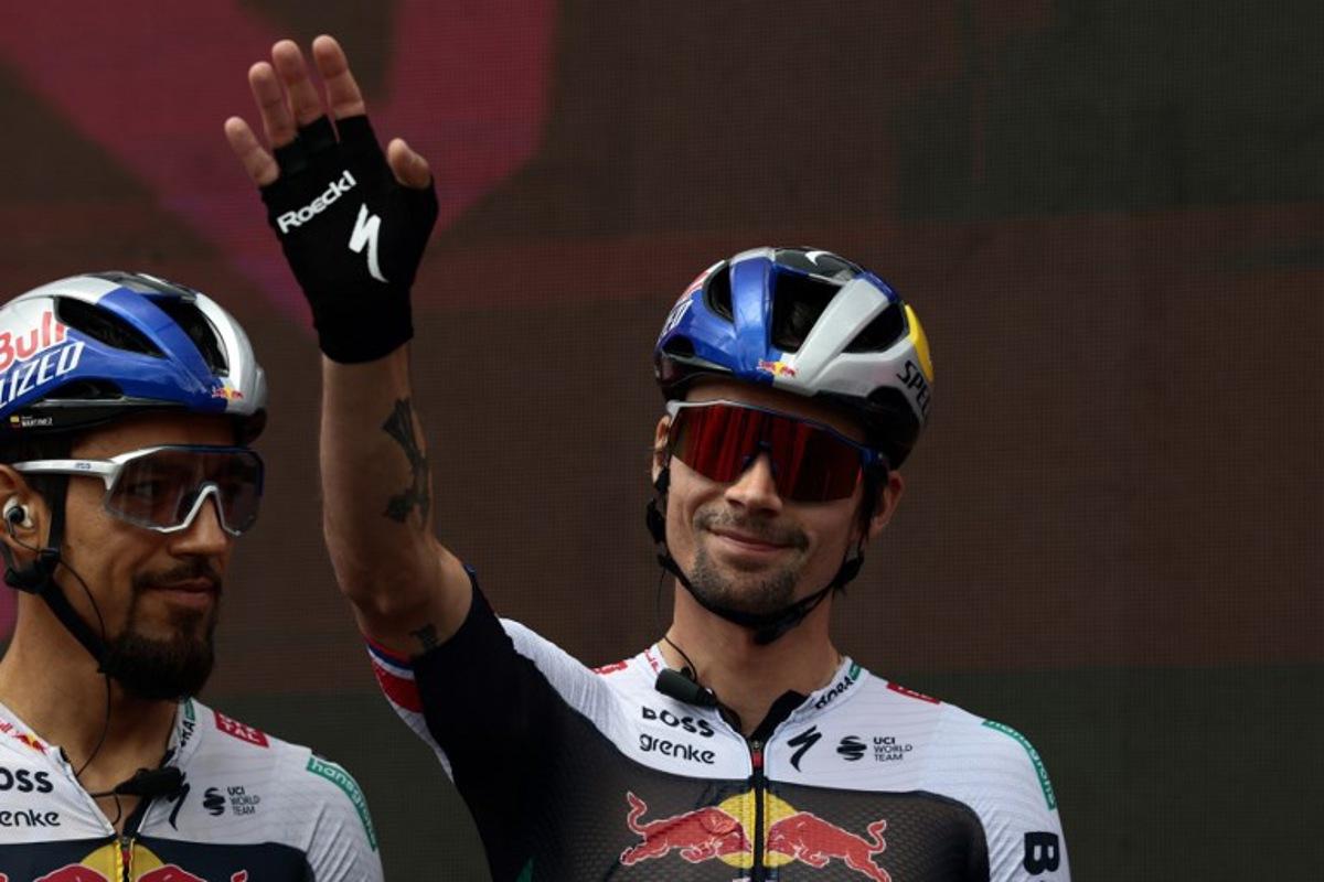 Red Bull-Bora-Hansgrohe's Slovenian rider Primoz Roglic waves during the ceremony held ahead of the start of the 9th stage of the 108th Giro d'Italia cycling race of 181kms from Gubbio to Siena on May 18, 2025.  Luca Bettini / AFP