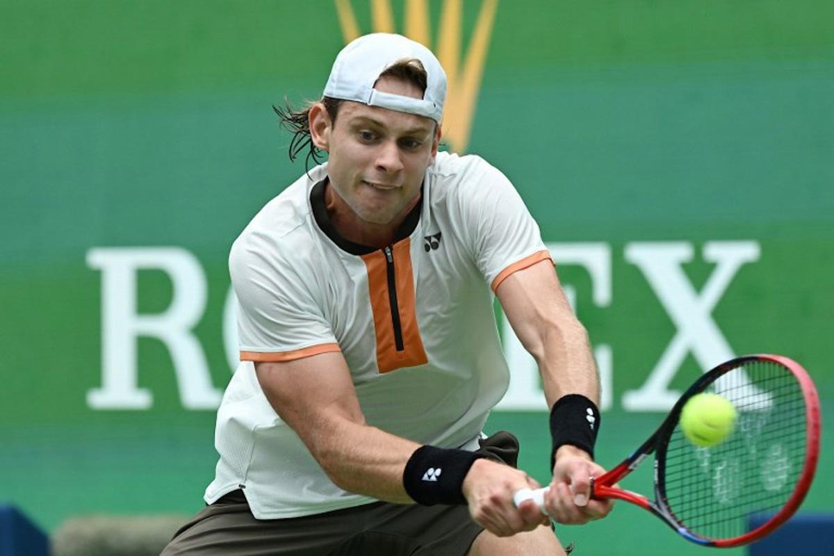 Belgium's Zizou Bergs hits a return to Canada's Gabriel Diallo during their men's singles match at the Shanghai Masters tennis tournament in Shanghai on October 7, 2025.  Jade Gao / AFP