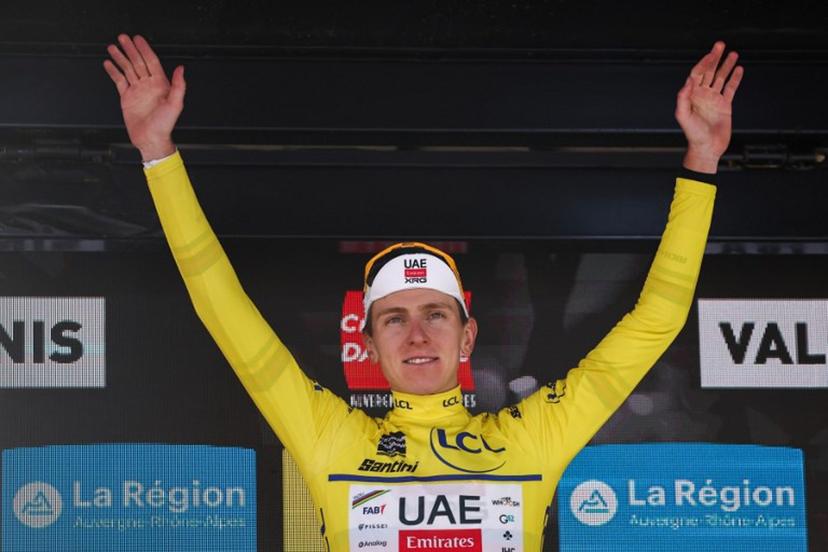 UAE Team Emirates XRG's Slovenian rider Tadej Pogačar wearing the overall leader's yellow jersey celebrates winning the overall race on the podium of the 8th and final stage of the 77th edition of the Criterium du Dauphine cycling race, 133,3 km between Val-d'Arc and Val-Cenis - Plateau du Mont Cenis, on June 15, 2025.  Anne-Christine POUJOULAT / AFP