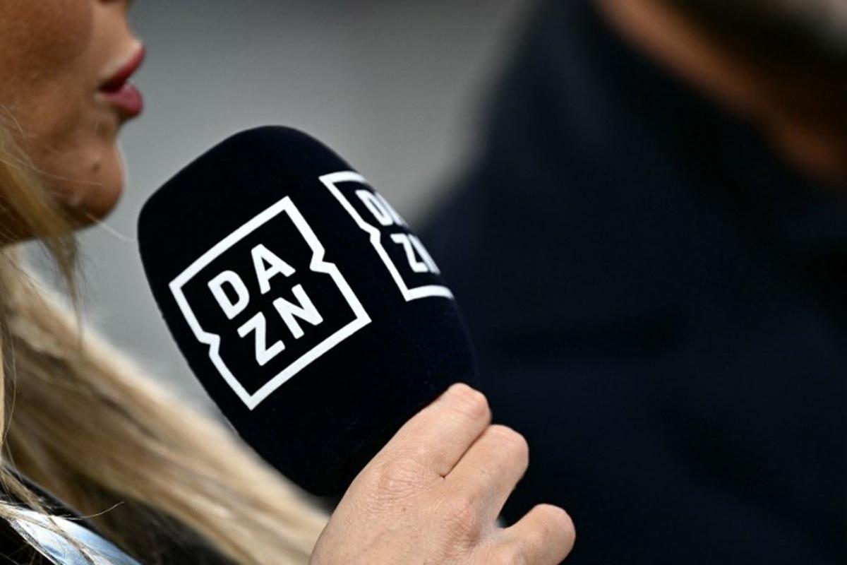 A presenter of sports streaming service DAZN holds a microphone during the Italian Serie A football match between Juventus and Cagliari, at The Allianz Stadium, in Turin on November 11, 2023.  GABRIEL BOUYS / AFP
