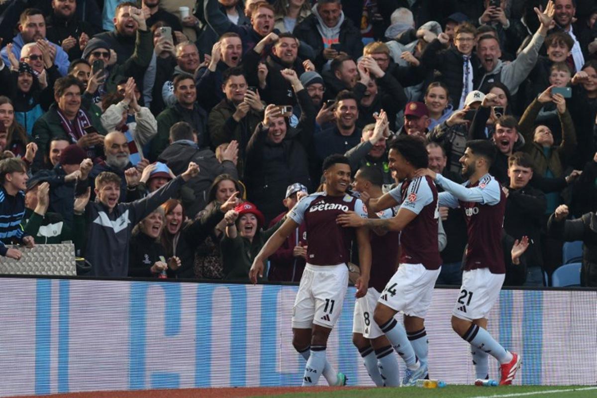Aston Villa's English striker #11 Ollie Watkins (L) celebrates with teammates after scoring the openin goal during the English Premier League football match between Aston Villa and Newcastle United at Villa Park in Birmingham, central England on April 19, 2025.  Darren Staples / AFP