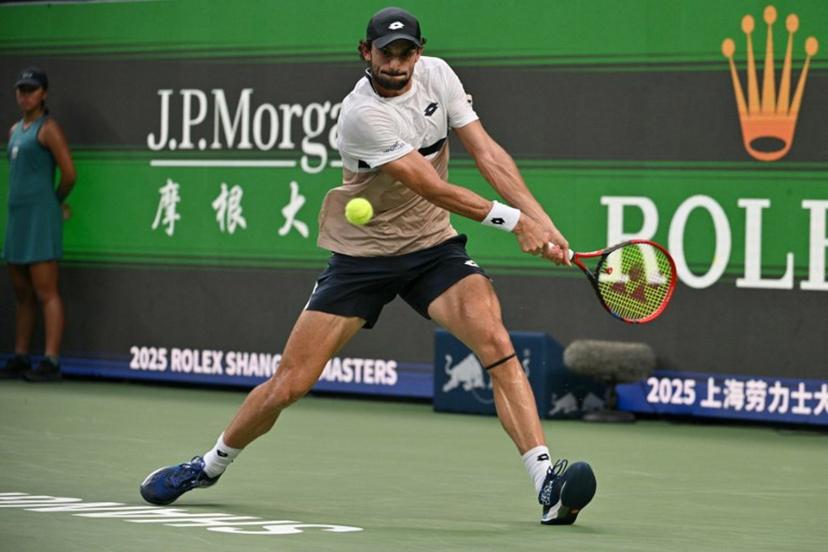 Monaco's Valentin Vacherot hits a return to Serbia's Novak Djokovic during their men's singles semi-final match at the Shanghai Masters tennis tournament in Shanghai on October 11, 2025.  HECTOR RETAMAL / AFP