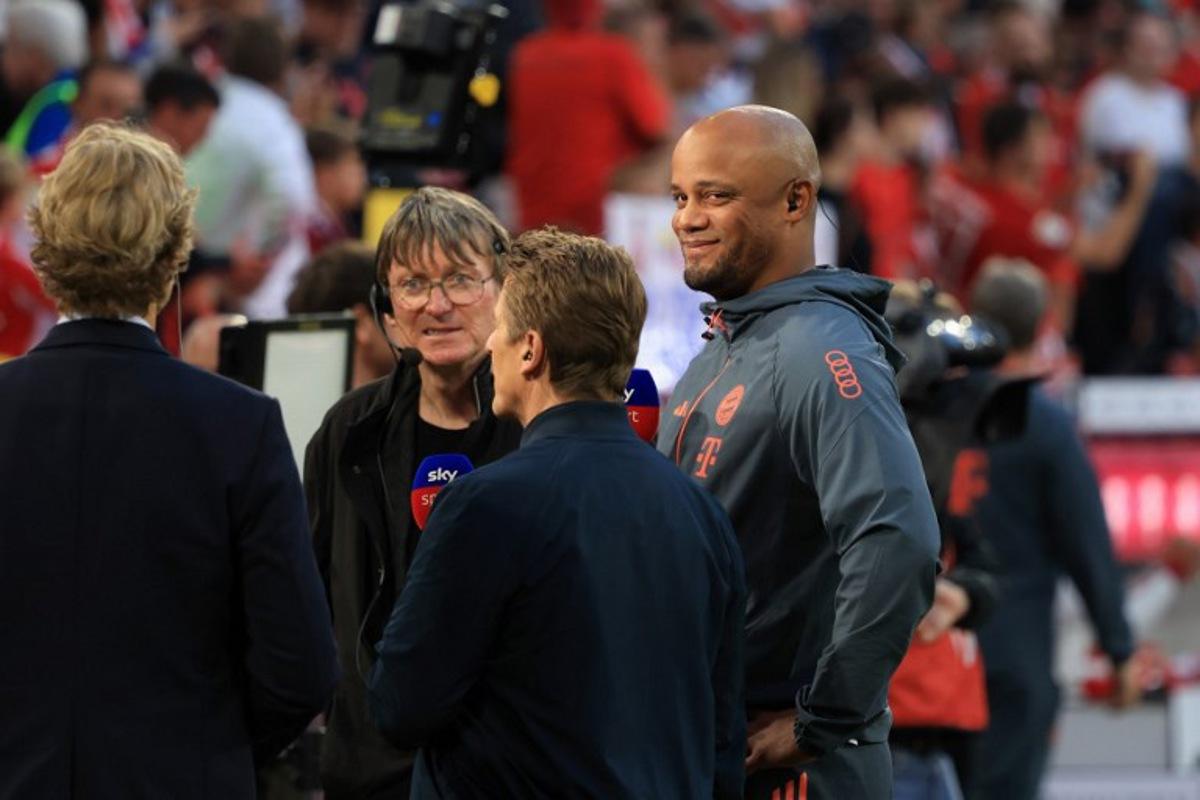 Bayern Munich's Belgian head coach Vincent Kompany (R) looks on during an interview prior to the German first division Bundesliga football match between FC Bayern Munich and RB Leipzig in Munich, southern Germany, on August 22, 2025.  Karl-Josef Hildenbrand / AFP