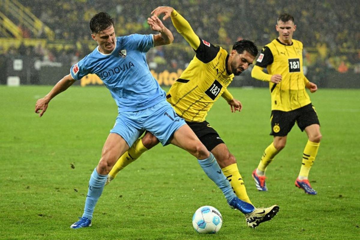 Bochum's German defender #14 Tim Oermann (L) and Dortmund's German midfielder #23 Emre Can vie for the ball during the German first division Bundesliga football match between BVB Borussia Dortmund and VfL Bochum in Dortmund, western Germany on September 27, 2024.  INA FASSBENDER / AFP