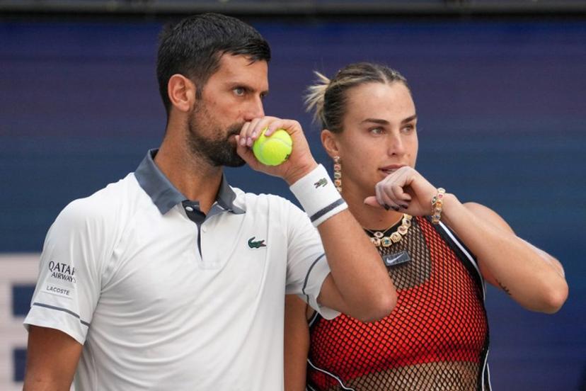 Serbia's Novak Djokovic (L) and Belarus's Aryna Sabalenka (R) speak with each other during their mixed doubles tennis match against Czech Republic's Katerina Siniakova and Britain's Henry Patten during Fan Week as part of the 2026 US Open tennis tournament at the USTA Billie Jean King National Tennis Center in New York, on August 25, 2026.  TIMOTHY A. CLARY / AFP