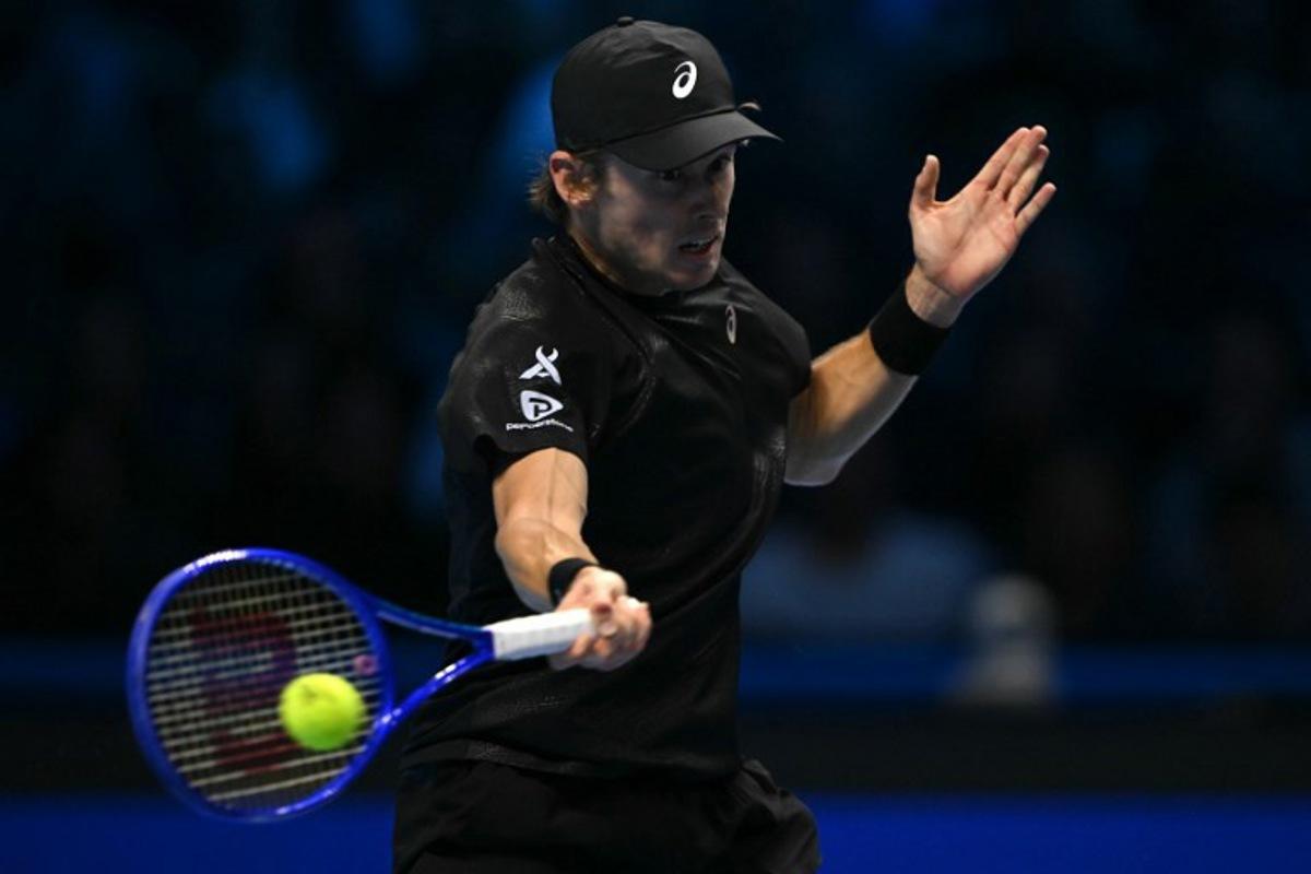 Australia's Alex De Minaur hits the ball during his match against Italy's Lorenzo Musetti at the ATP Finals tennis tournament in Turin on November 11, 2025.  Marco BERTORELLO / AFP