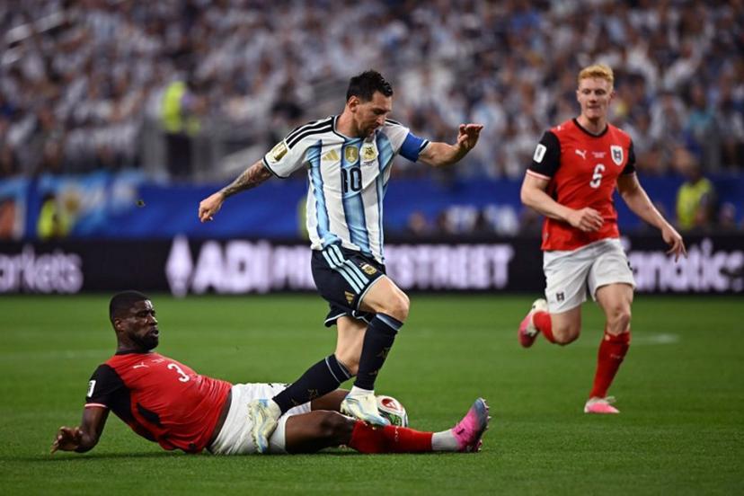 Argentina's forward #10 Lionel Messi (R) fights for the ball with Austria's defender #03 Kevin Danso (L)  during the 2026 World Cup Group J football match between Argentina and Austria at the Dallas Stadium in Arlington on June 22, 2026.   Paul ELLIS / AFP