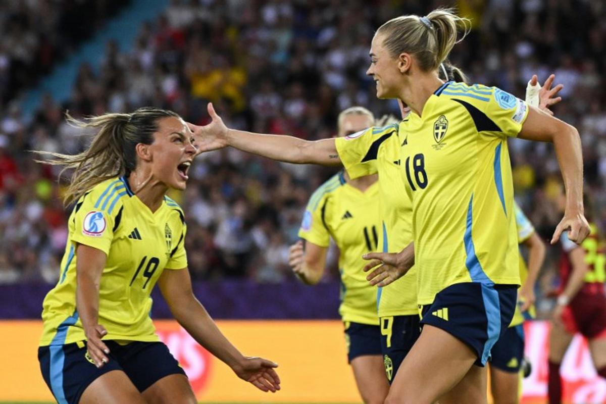 Sweden's forward #19 Johanna Rytting Kaneryd (L) reacts after Sweden's forward #18 Fridolina Rolfo (R) scored her team's third goal during the UEFA Women's Euro 2025 Group C football match between Sweden and Germany at Letzigrund Stadium in Zurich, on July 12, 2025.  Miguel MEDINA / AFP