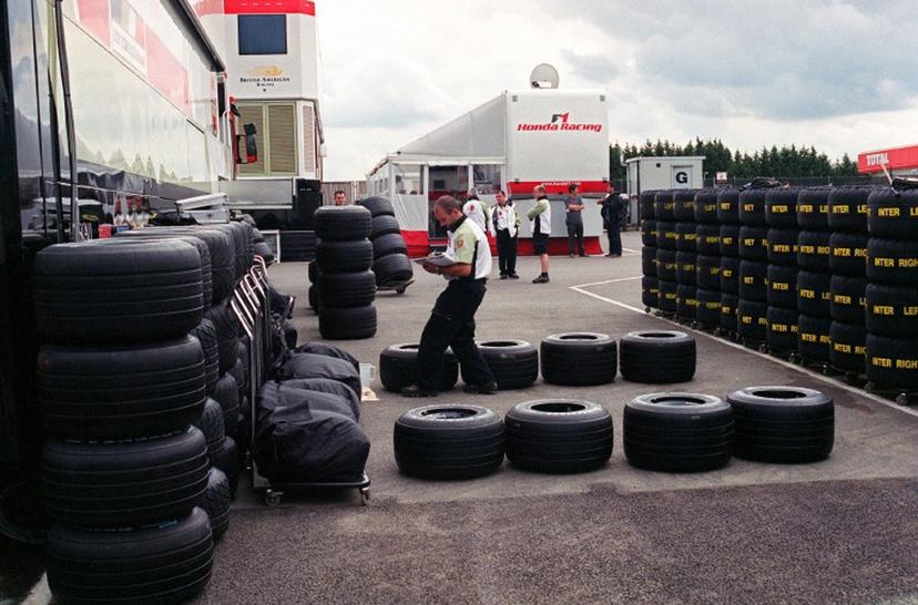 A BAR-Honda technician checks the Bridgestone tires available for the two racing cars during the British Formula One Grand Prix 05 July 2002 in the paddocks of the Silverstone racetrack.  AFP PHOTO JEAN-PIERRE MULLER  JEAN-PIERRE MULLER / AFP